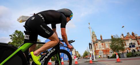 How does riding a TT Bike differ from a road bike?